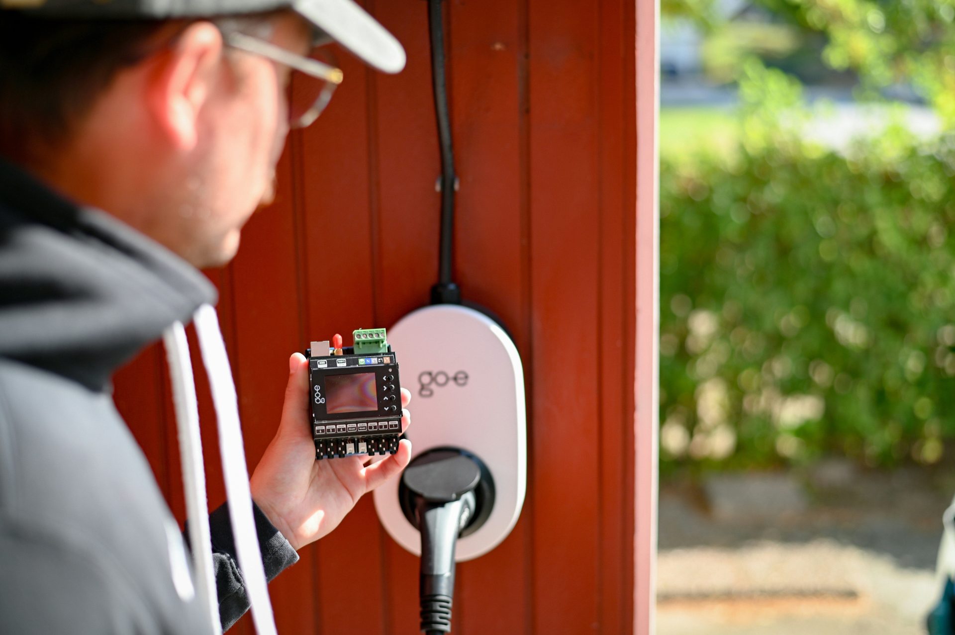 Man is examining an electric vehicle charger